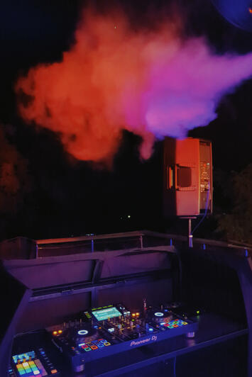 Wedding DJ setup with Pioneer decks, JBL speakers and lighting