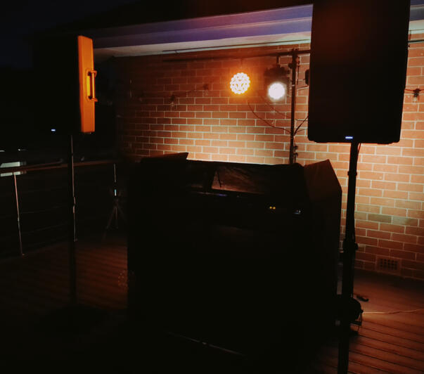 Wedding DJ setup with Pioneer decks, JBL speakers and lighting